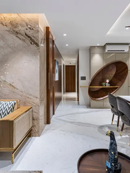 An alternate view of the Filigree House, showing the unique, curved wooden shelving unit in the dining area. This bespoke piece acts as both storage and sculpture, adding an artistic touch to the space.