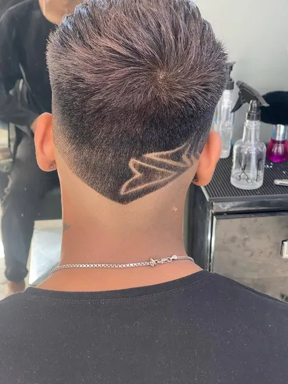 A bold V-shaped neckline with an intricate geometric pattern inside. This is a great example of a custom nape design.