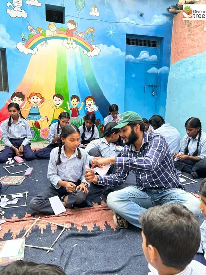 A team member gives one-on-one guidance to a student, ensuring everyone can participate and create something they are proud of.