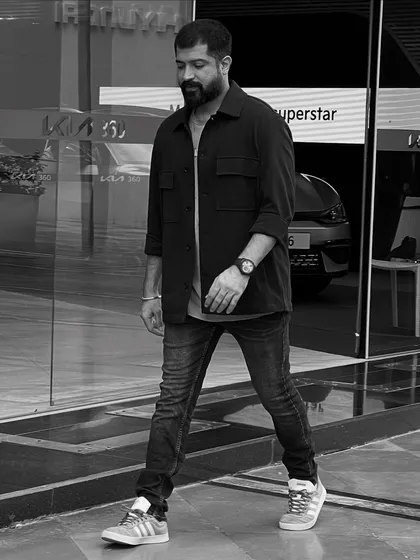 A candid black and white photo, capturing a moment of thought while on the move.
