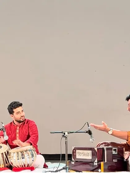 Explaining a rhythmic concept to my accompanist and the audience at Triveni Kala Sangam.