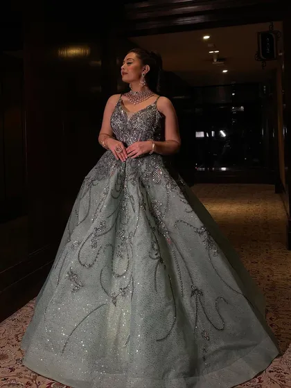 Another angle of our mint shimmer organza gown, showing the intricate patterns of the crystal and sequin work. The delicate spaghetti straps and fitted bodice create a flattering and feminine shape.