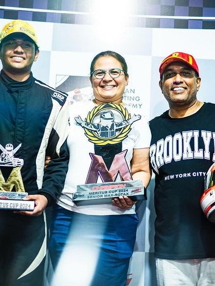 A driver and his family celebrating a championship win.