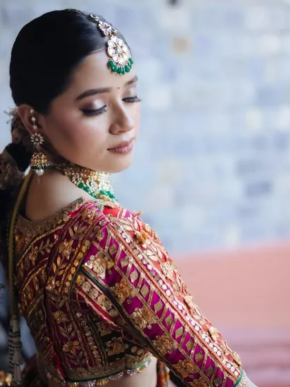 A beautiful close-up portrait of a bride, showcasing the intricate embroidery on her blouse.