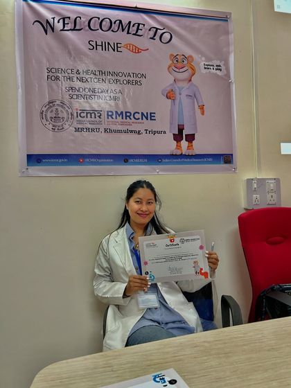 Holding my certificate of participation from the 'Shine' event. It was an honor to contribute to this inspiring program.