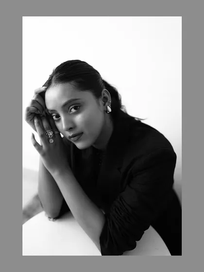 A classic black and white portrait that emphasizes emotion and form. This style of photography is timeless, perfect for creating powerful headshots or fashion images where the subject's expression is the main focus.