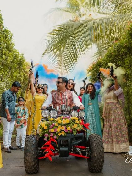 Another angle of the couple's grand Haldi entry, showing the full effect of the colorful smoke bombs and the excitement of the wedding party.