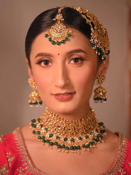 A full-face view of this elegant look. The makeup is traditional yet fresh, perfect for a modern bride.