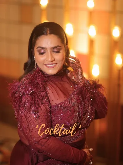 A rich, monochromatic look for a cocktail event. The makeup features a deep berry eye and lip that matches her stunning feathered outfit.