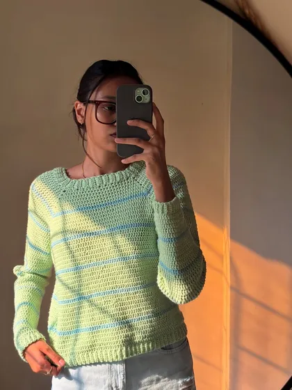 Golden hour hitting this cozy striped crochet sweater. The fit is relaxed, and the neckline is a classic boatneck style.