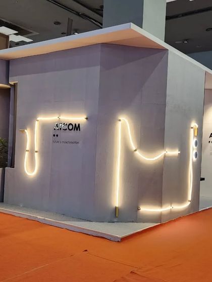 The full exterior of our Acetech 2022 booth, featuring the flexible Medusa rope light tracing a path across the facade.