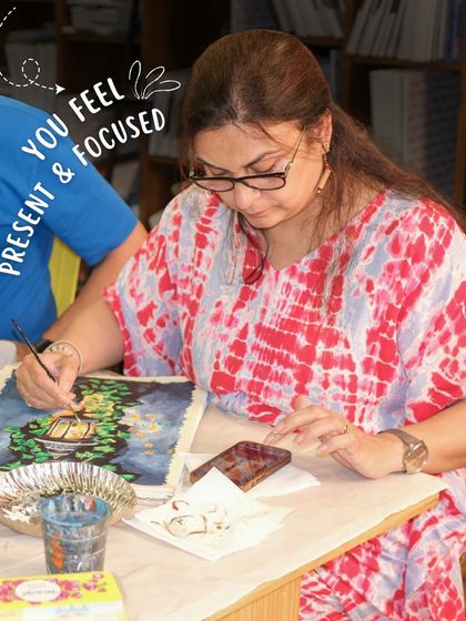 A participant focuses intently on her painting, fully present in the creative moment. My studio is a space to disconnect from stress and reconnect with yourself.