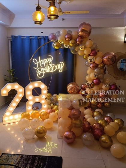 The warm lighting from the pendant lamps and the marquee numbers creates a cozy yet celebratory atmosphere.