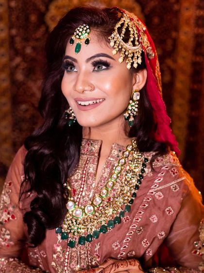 Her happy smile shows how comfortable and beautiful she feels. We work closely with our brides to ensure the final look is exactly what they dreamed of.