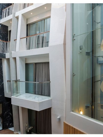 The interior courtyard of the Cleft House reveals a complex interplay of volumes, light, and material. The central void connects different levels of the home, promoting interaction and providing views across the space.