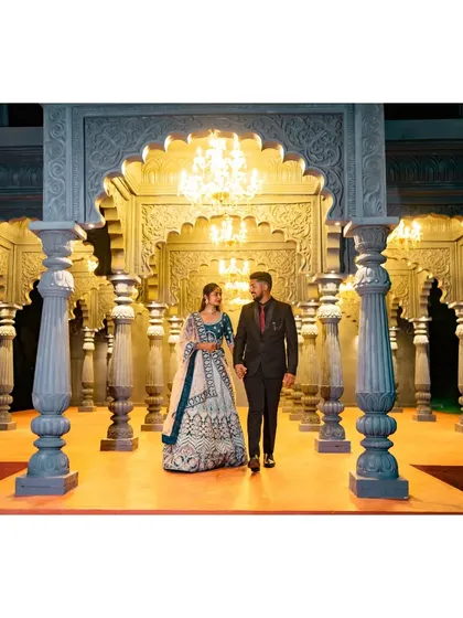 A grand entrance for a beautiful beginning. This couple walks hand-in-hand through a majestic, palace-like hall, perfect for a royal-themed pre-wedding photoshoot.
