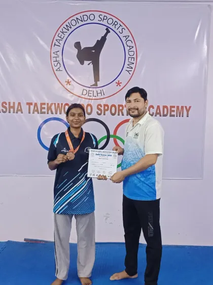 One of our dedicated adult students showcasing her medal from the Delhi Games. Our training is for all ages and skill levels.