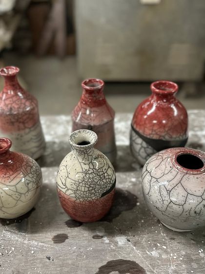 The beautiful results of a Raku workshop. These vases and pots show a variety of shapes and the stunning crackled patterns that make each piece one-of-a-kind.