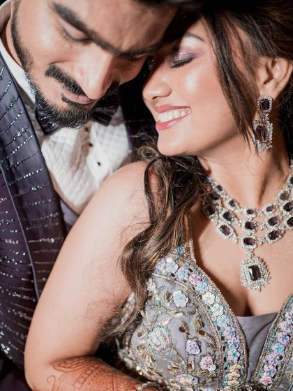 A close-up that captures pure joy. The bride's radiant smile and sparkling eye makeup are the highlights of this beautiful reception moment.