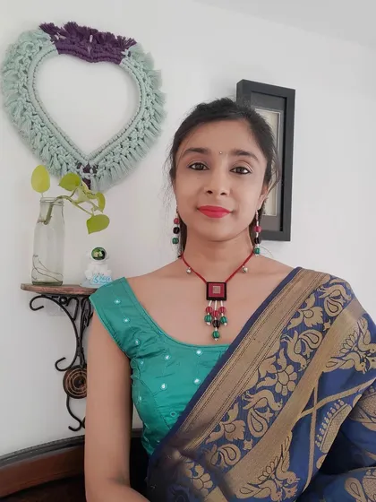This beaded necklace set with a fabric pendant is perfect for both Navratri and other festive events. The combination of red, green, and black beads with small ghungroos adds a playful touch to any outfit.