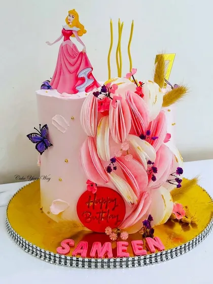 A royal celebration with Princess Aurora. This cake features unique wafer paper flower details, adding a modern and delicate touch to the princess theme.