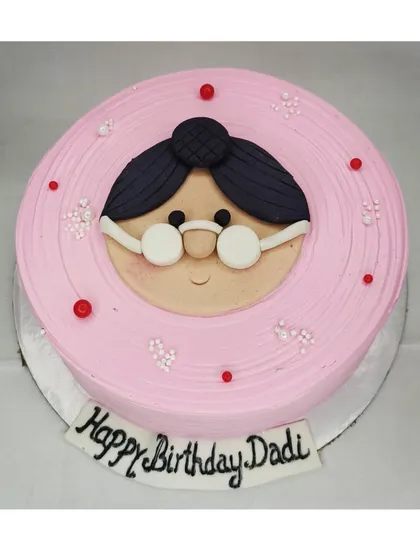 A special cake for a grandmother's birthday. This mixed fruit cake features a cute, handmade fondant face of a "Dadi" with glasses.