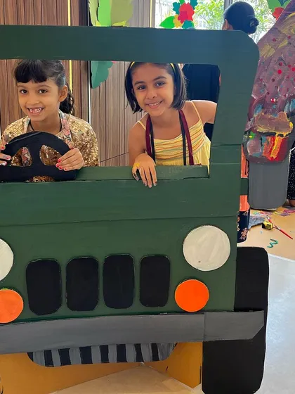 Our workshops are not just about painting; they are about building worlds. Here, two of our campers are ready to drive off on a jungle safari in a jeep they helped design and paint themselves. This is where 3D construction meets imaginative play.