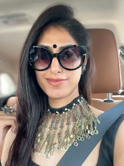 Accessories are the secret to elevating any outfit. In this selfie, I'm wearing a statement tribal necklace that adds personality and a touch of drama to a simple black top.