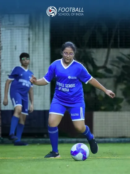 We are committed to empowering all athletes, and our girls' football program is a testament to that. Here, a young player confidently controls the ball during a training session, showcasing the skill and focus we nurture in every member of our academy.