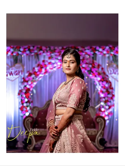A classic portrait of the bride standing before the floral arch at her wedding venue, capturing her in the context of her beautifully decorated event.