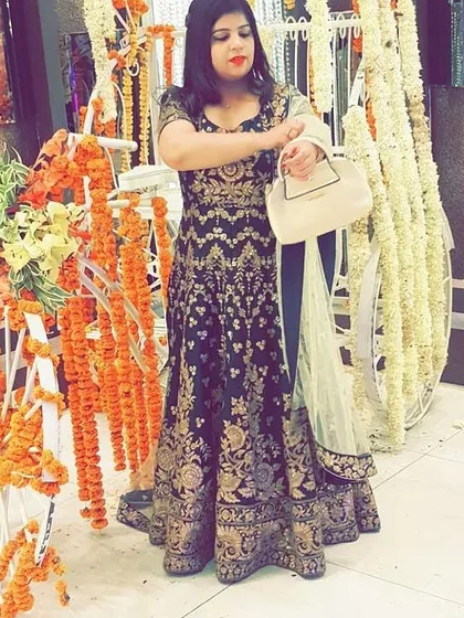 The same client at a wedding event, showing how the Anarkali looks in a festive setting. The rich color and detailed work make it stand out beautifully.