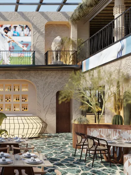 The bar at Skyro is a sculptural, backlit form that glows against the textured walls. The design is both functional and artistic, serving as a focal point for the main dining area.