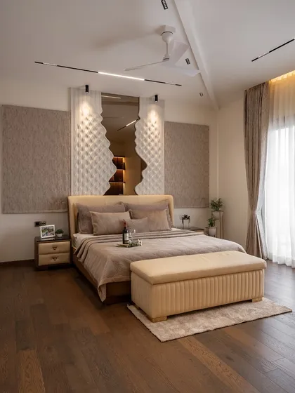 A master bedroom should be a private retreat that restores and reflects your personal style. Here, we combined mood-rich textures, a custom headboard, and warm wooden floors to create a luxurious sanctuary that feels like a five-star escape.