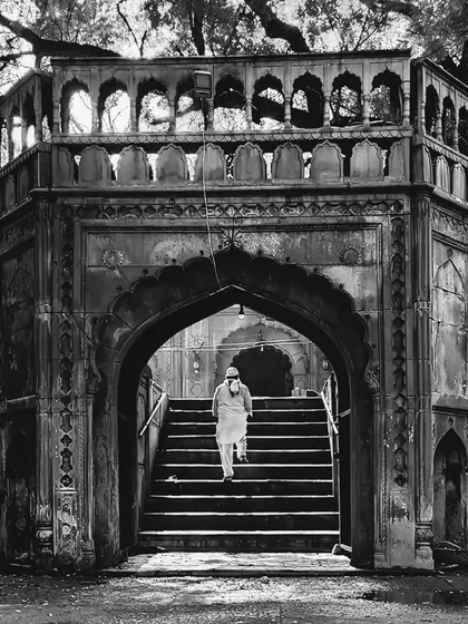 A striking black and white photograph of the Sunehri Masjid near the Red Fort. Built in the 18th century during the decline of the Mughal empire, its story is intertwined with the powerful court eunuch, Nawab Bahadur Javed Khan.