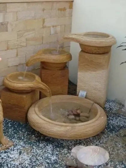 A collection of multi-tiered, handcrafted stone fountains. These self-contained water features are perfect for adding the gentle sound of flowing water to patios, balconies, or indoor spaces.