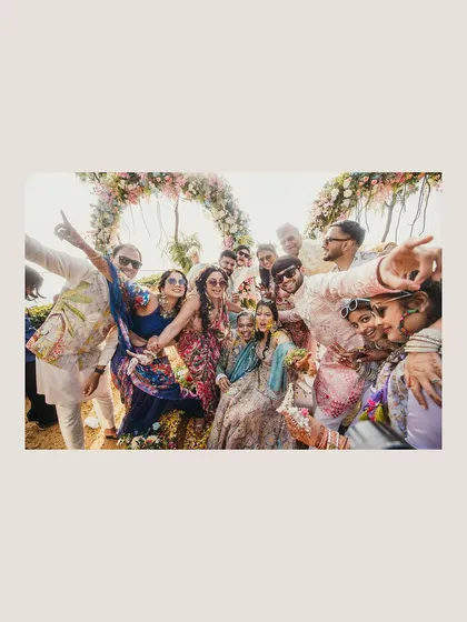 A candid group photo from the Haldi ceremony, full of energy and fun. This shot captures the collective joy of friends and family celebrating with the couple.