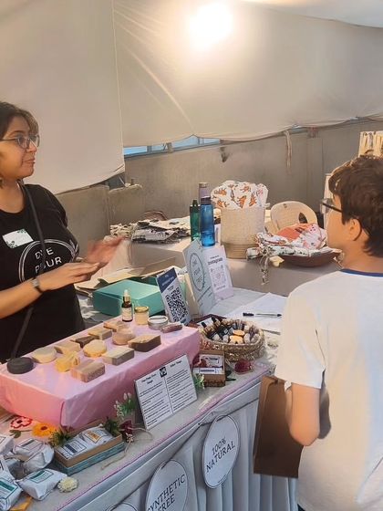 Explaining my products to a young customer and his mom at The Golden Spiral School fair. I believe in educating the next generation about conscious skincare.