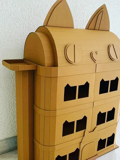 The playful details of the cat dollhouse, from the ears on top to the heart-shaped nose, make it a delightful project for kids to build and enjoy.