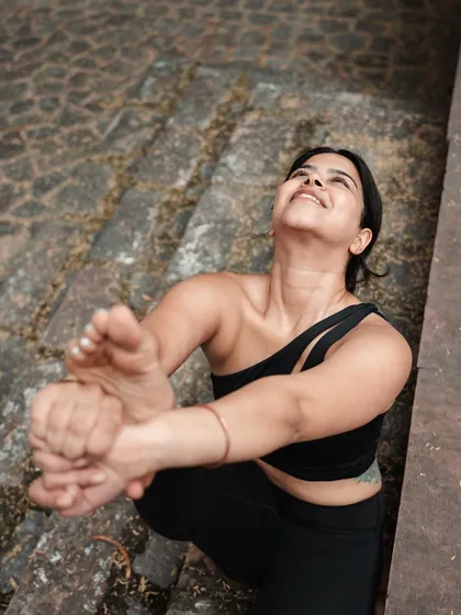 Looking up during Krounchasana. The secret lies in putting in the effort without judgment, accepting where your body is each day.