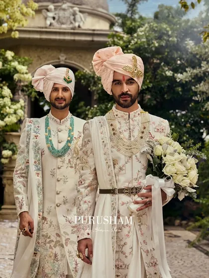 Here, two grooms stand together, each in a unique yet coordinated floral sherwani. I believe in creating ensembles that celebrate shared stories, ensuring both partners feel equally regal. This is a testament to love's legacy, detailed in soft hues and intricate threadwork.