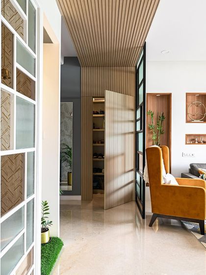 Here is the hidden shoe storage revealed. A gentle push opens the seamless fluted panel door, showcasing the spacious shelves inside. This is a perfect example of how I integrate function and aesthetics.