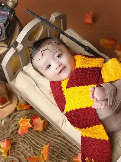 A sleepy little wizard. This adorable shot shows a newborn version of the Harry Potter theme, perfect for the tiniest fans.