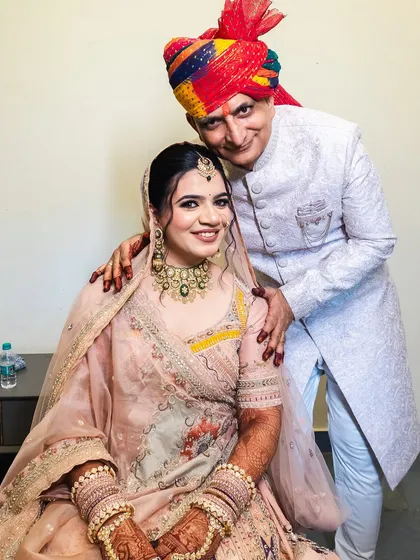 A heartwarming photo of the bride with her father, a precious family moment.