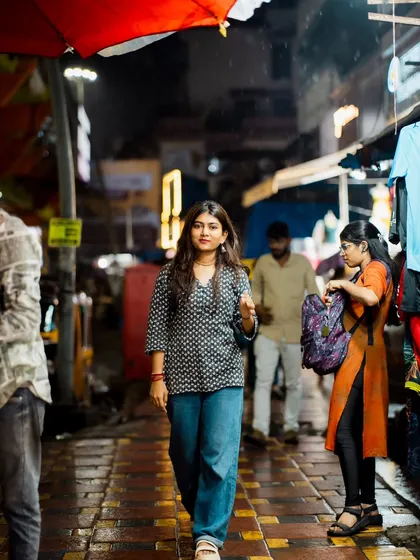 A walking shot that captures the feeling of a night out in the city. The red umbrella adds a nice splash of color.