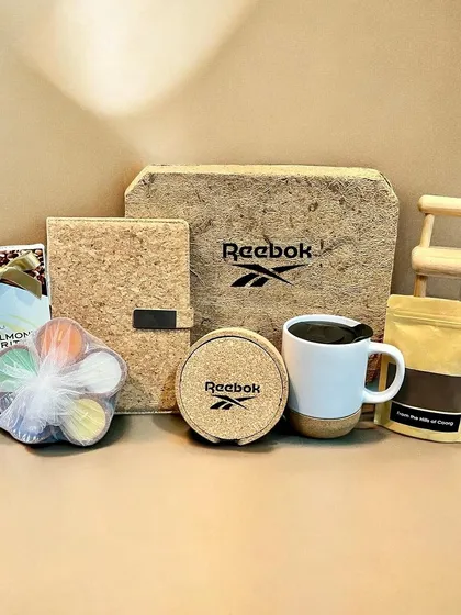 I partner with global brands like Reebok to create sustainable corporate gifts. This eco-friendly hamper features branded cork items and other treats, perfectly aligning with their brand values.