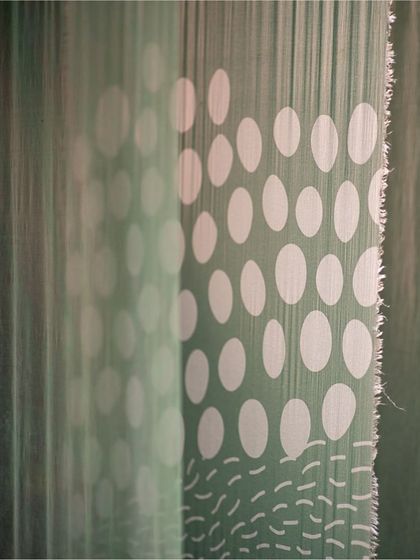 We believe every tiny aspect of a design adds a layer of meaning. This close-up of a fabric detail from the 'Cherish' exhibit shows our attention to printing techniques, dye colors, and textures, which are fundamental to our narrative experience design.