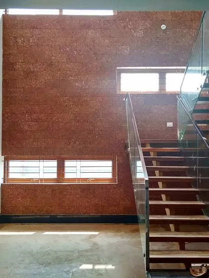 Natural light is a key material in my designs. This double-height courtyard uses a large skylight to illuminate the space, highlighting the rich texture of the laterite stone wall and the clean lines of the modern floating staircase.