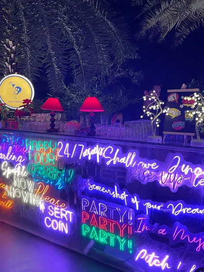Our custom neon bar, shown here at a private birthday party. The bright, colorful signs are fully customizable to match your event's theme or display a special message for your guests.
