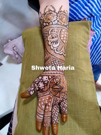 The other arm of the heavy guest design, showcasing a large peacock and intricate check patterns.