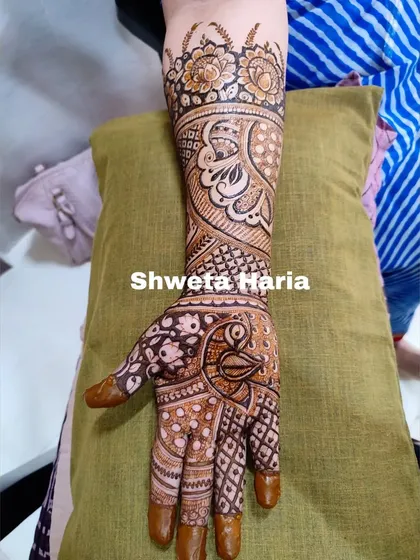 A heavy Indian design covering the full arm. This intricate artwork combines peacock figures with paisley patterns and delicate floral vines for a classic and dense look.